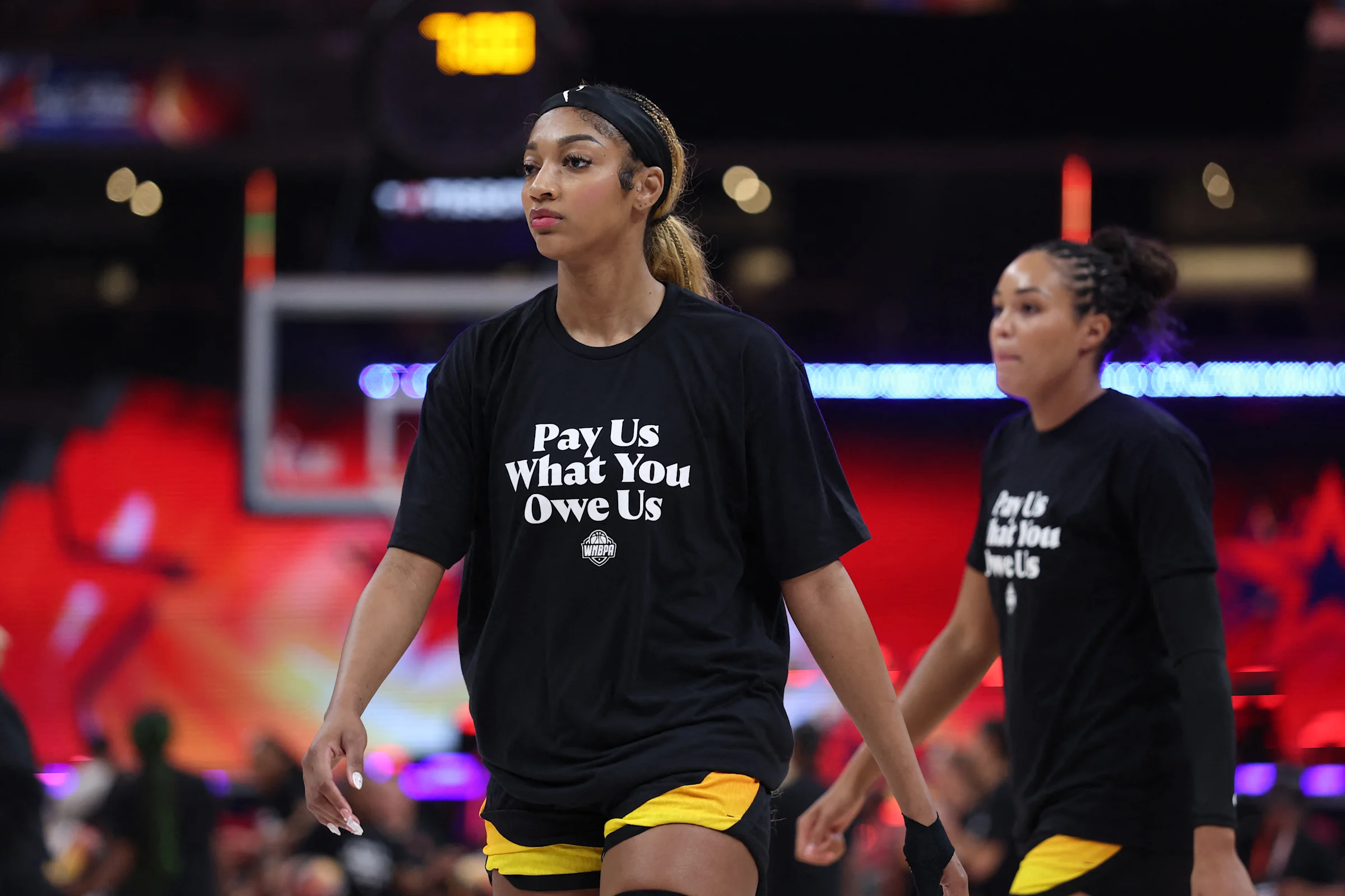 WNBA players wearing Pay Us What You Owe Us shirts